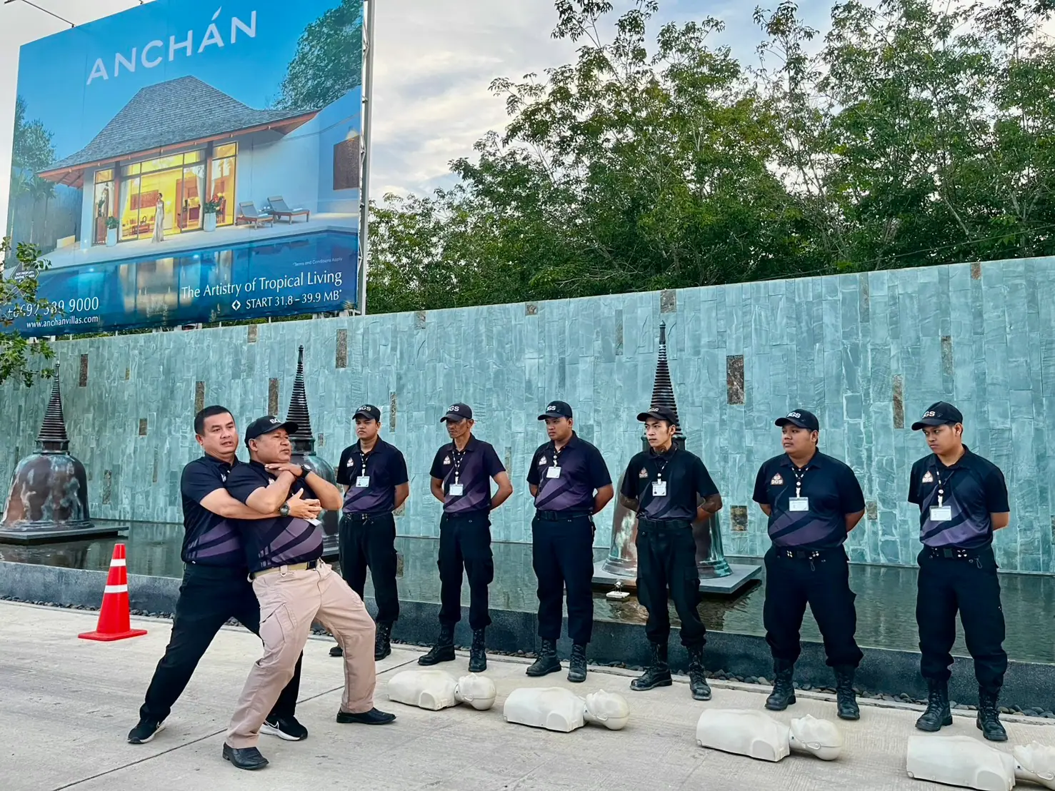 SGS instructor demonstrating the abdominal thrust position on a volunteer during choking-response training at Anchan, Phuket