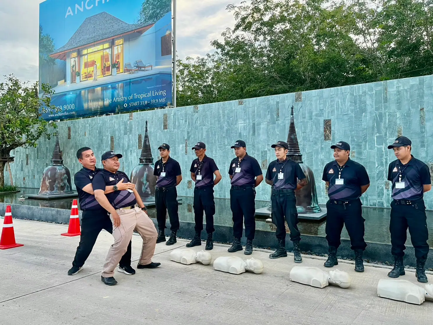 SGS instructor demonstrating first aid to security officers beside CPR manikins at Anchan, Thalang, Phuket