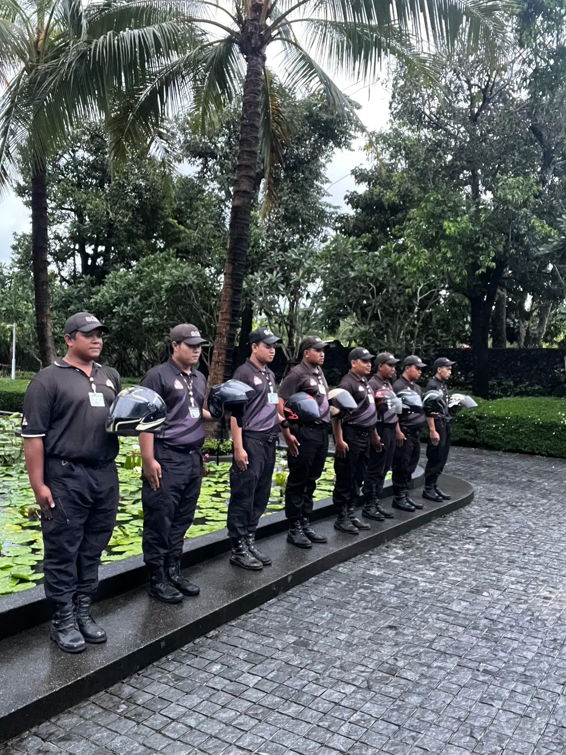 SGS officers standing to attention in uniform with ID cards at Anchan Villas